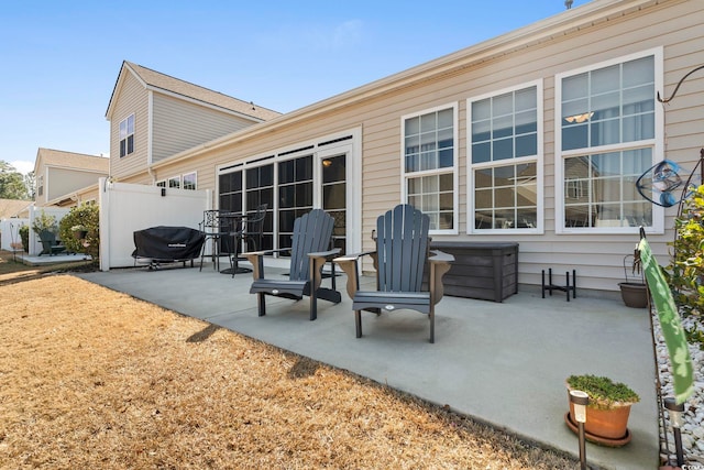 exterior space featuring fence and a grill