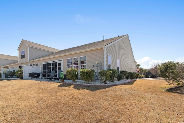 back of house featuring a lawn