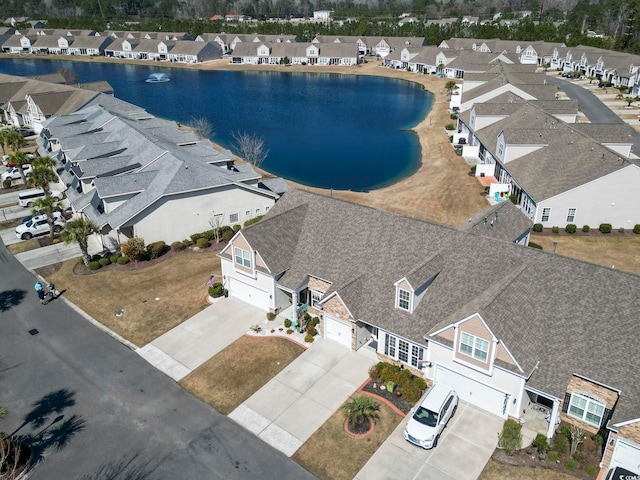 drone / aerial view featuring a water view and a residential view