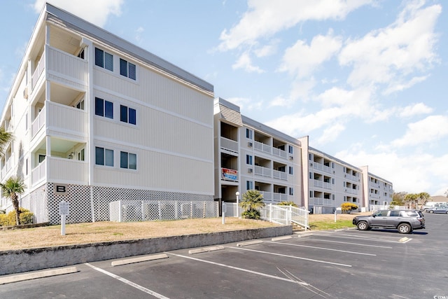 view of building exterior featuring uncovered parking