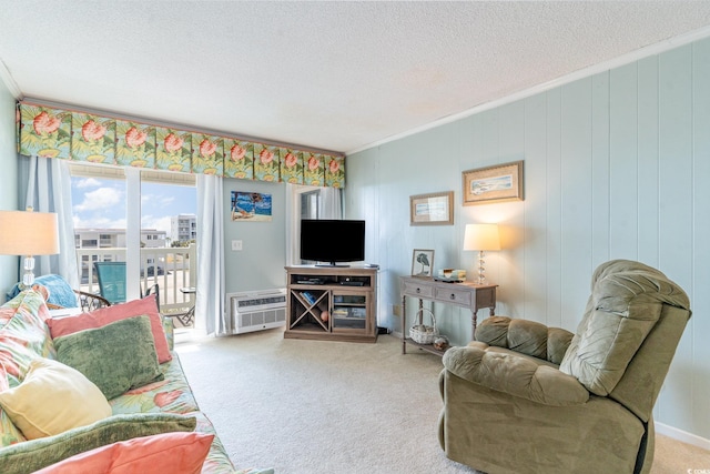 living room featuring carpet, ornamental molding, a textured ceiling, and a wall mounted AC