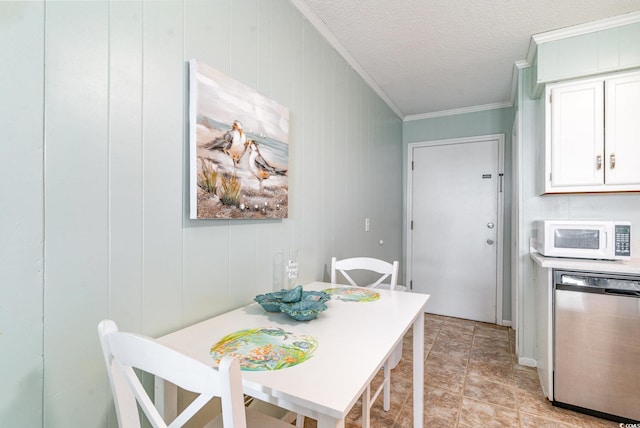 dining area with ornamental molding and a textured ceiling