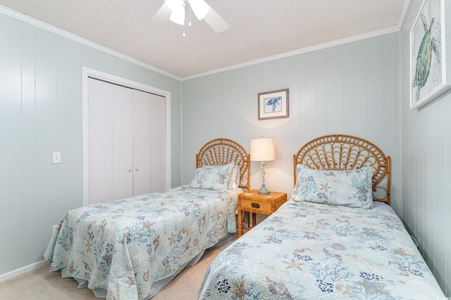 bedroom featuring crown molding, a closet, a ceiling fan, light carpet, and a textured ceiling