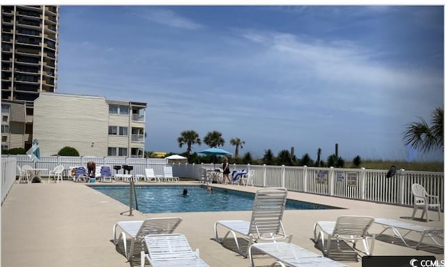 pool featuring a patio area and fence