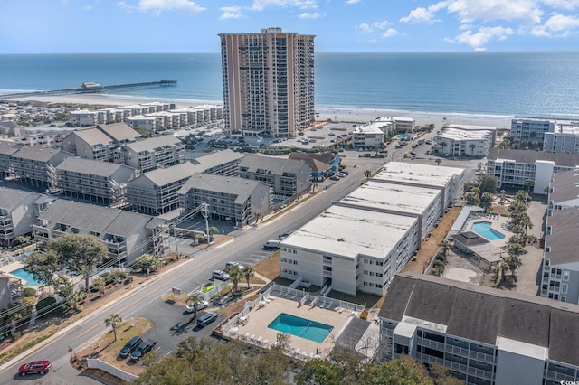 bird's eye view with a water view, a view of city, and a beach view