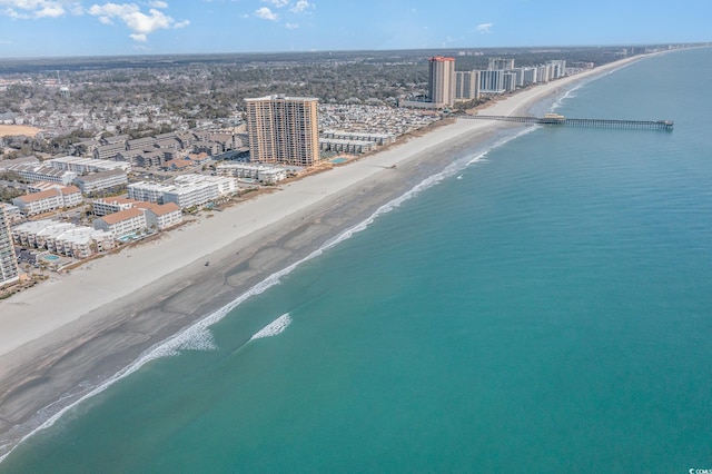 bird's eye view featuring a water view, a view of the beach, and a city view