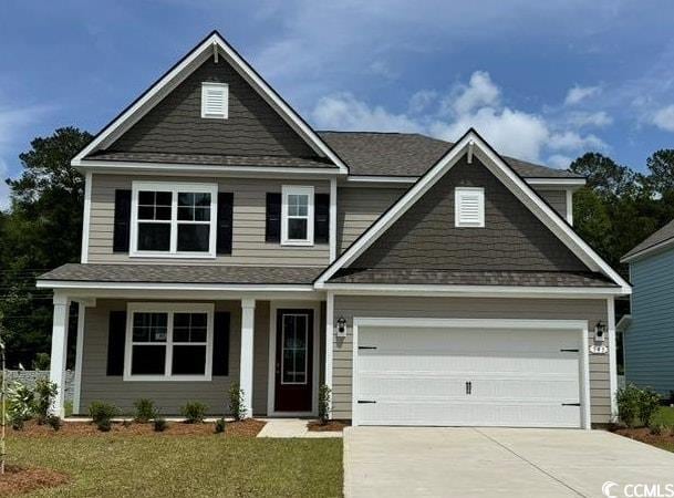 view of front facade with concrete driveway, a front lawn, a shingled roof, a garage, and a porch