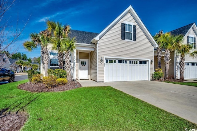 view of front of house featuring a garage, driveway, and a front lawn