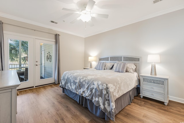 bedroom with ornamental molding, wood finished floors, and access to exterior