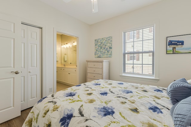 bedroom with ceiling fan, dark wood-type flooring, a closet, and connected bathroom