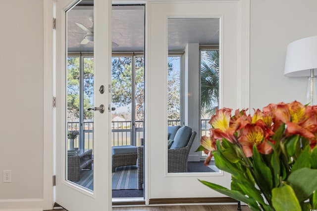 doorway with french doors and a ceiling fan