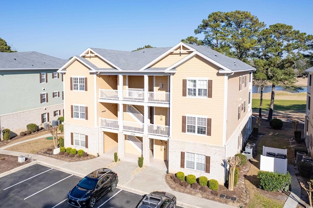 view of building exterior featuring uncovered parking and a residential view