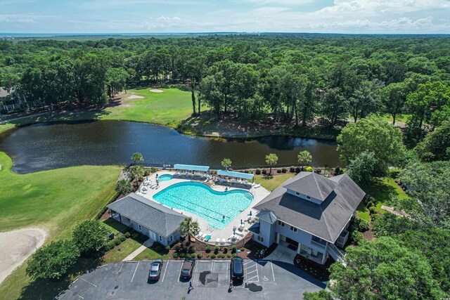 birds eye view of property featuring a water view and a view of trees