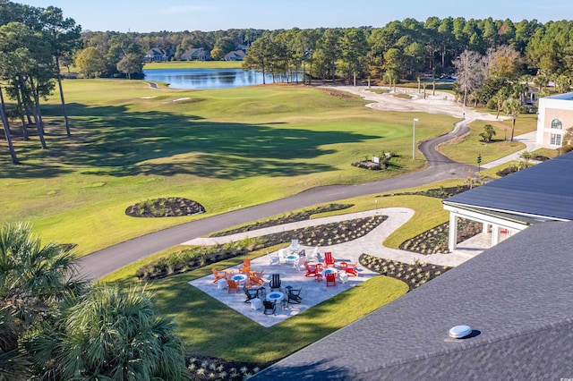 birds eye view of property with a water view and view of golf course