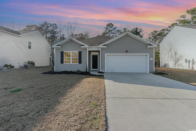 ranch-style home with a garage, a front yard, and concrete driveway