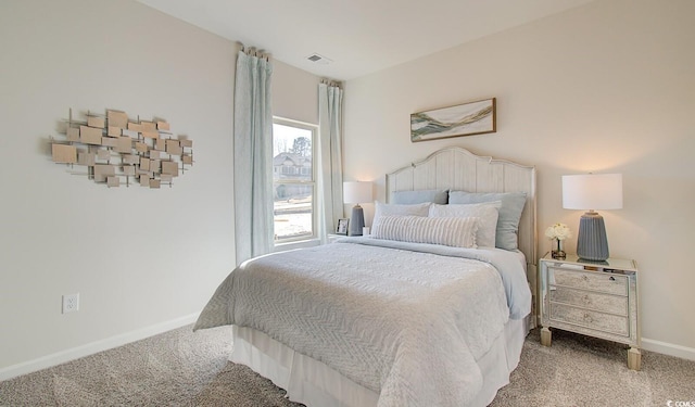 carpeted bedroom featuring visible vents and baseboards