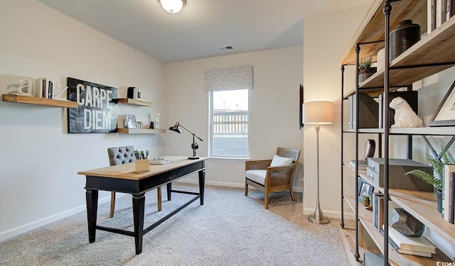 carpeted office with visible vents and baseboards