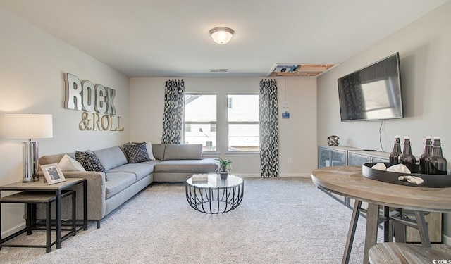 living area featuring baseboards, light carpet, and visible vents