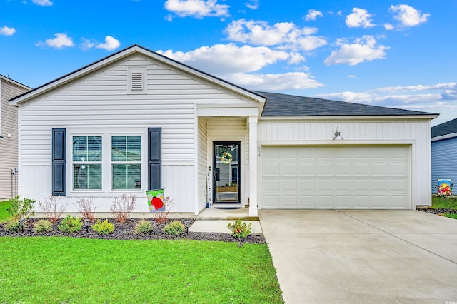 ranch-style house with an attached garage, a shingled roof, a front lawn, and concrete driveway