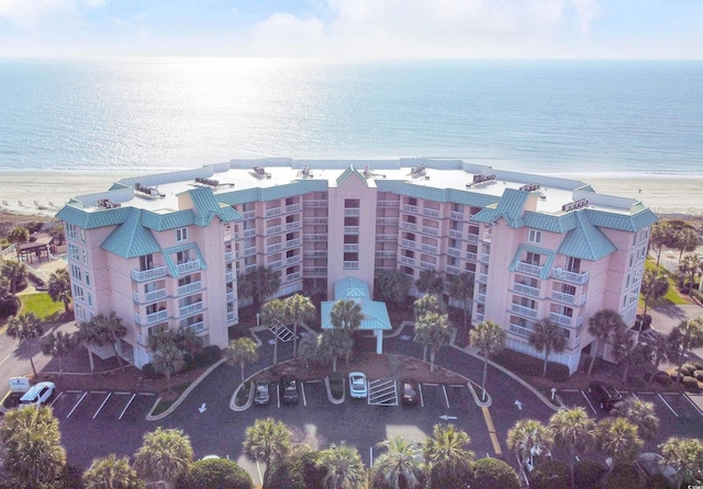 drone / aerial view featuring a beach view and a water view