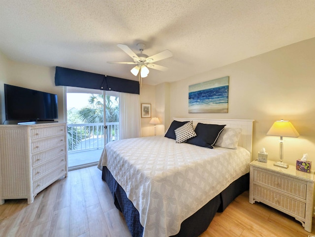 bedroom featuring a textured ceiling, access to outside, light wood-type flooring, and a ceiling fan