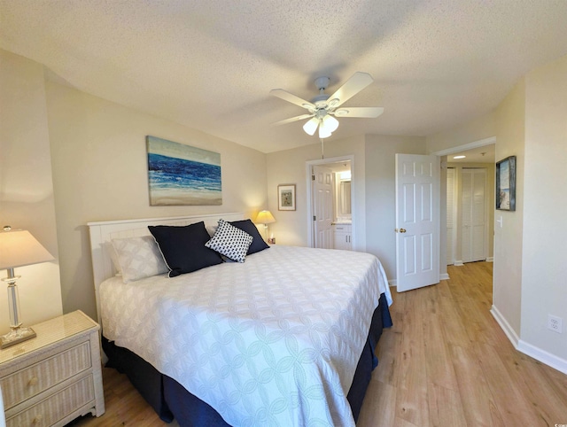 bedroom featuring a ceiling fan, baseboards, a textured ceiling, and light wood finished floors