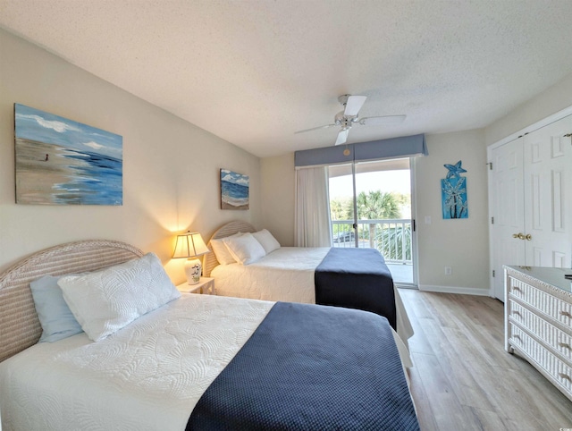 bedroom featuring a textured ceiling, ceiling fan, light wood-style flooring, baseboards, and access to outside