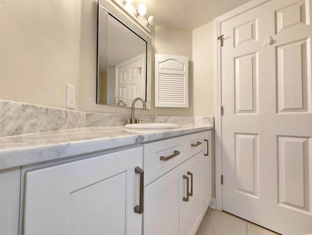 bathroom with tile patterned flooring and vanity