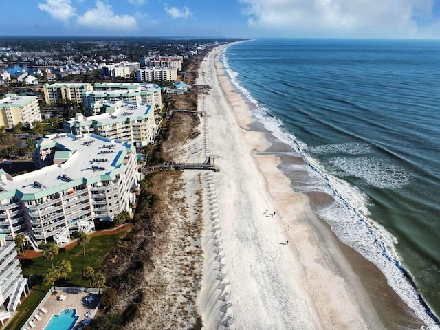 bird's eye view with a water view, a view of the beach, and a city view