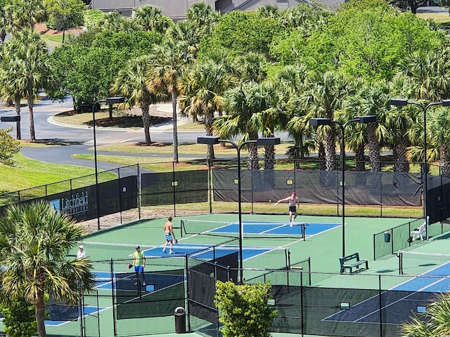 view of tennis court featuring fence