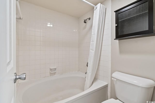 full bathroom featuring shower / tub combo and toilet