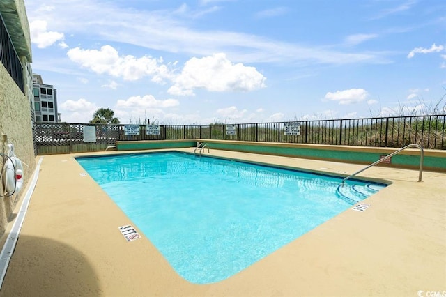 community pool featuring fence