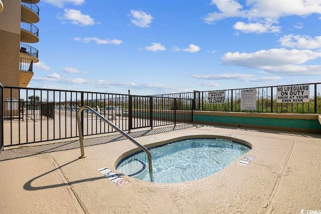 view of swimming pool with fence