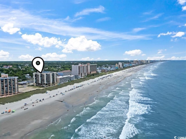 drone / aerial view with a beach view, a water view, and a city view