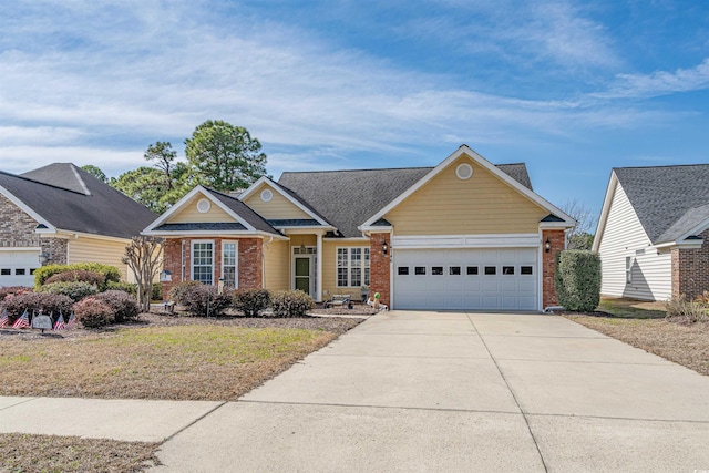 view of front of house with driveway, brick siding, and an attached garage