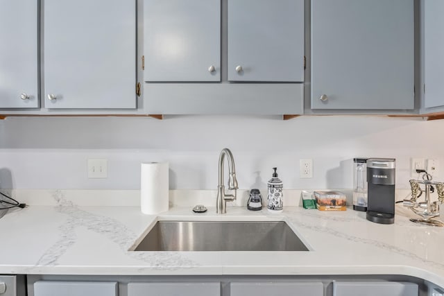 kitchen with gray cabinets and a sink