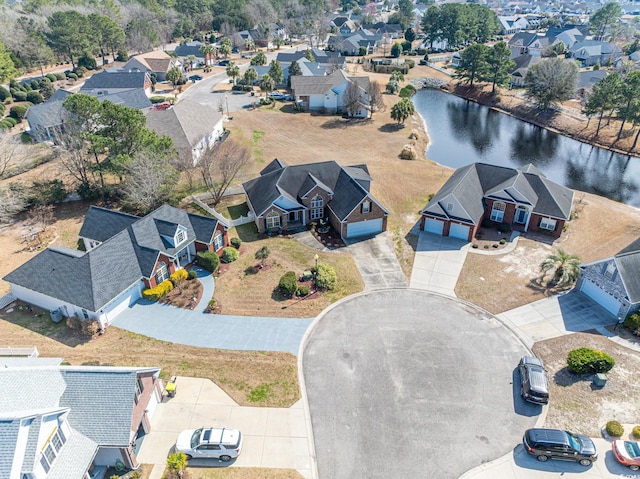 drone / aerial view featuring a residential view and a water view