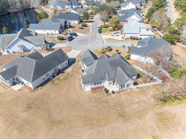 drone / aerial view with a water view and a residential view