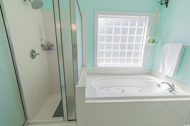 full bathroom with plenty of natural light, a whirlpool tub, and a shower stall