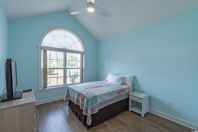 bedroom with dark wood finished floors, vaulted ceiling, ceiling fan, and baseboards