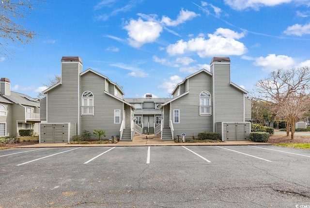 view of property featuring uncovered parking