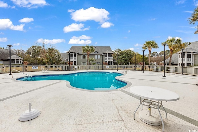 pool featuring a patio and fence