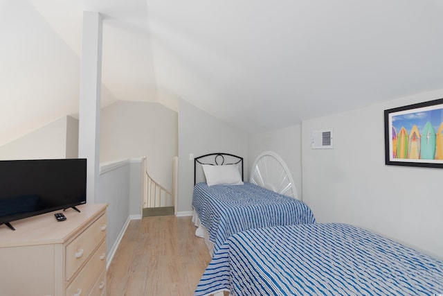 bedroom featuring light wood-type flooring and lofted ceiling