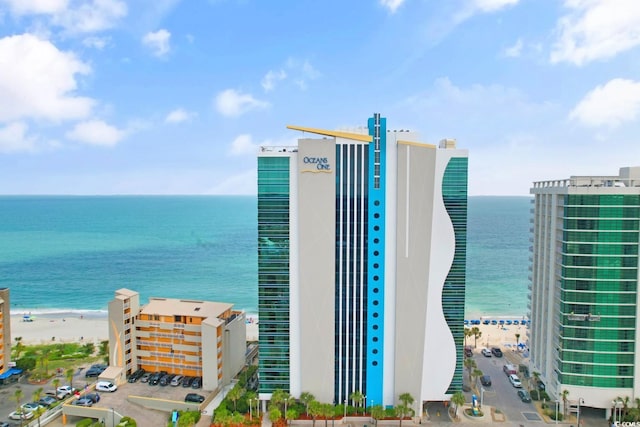 exterior space featuring a water view and a beach view