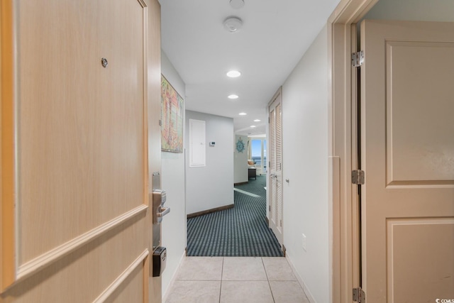 hallway with recessed lighting, baseboards, light colored carpet, and light tile patterned flooring