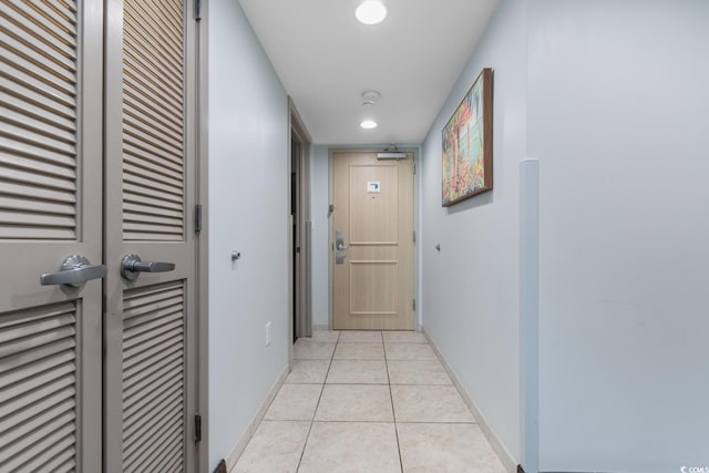 hall with recessed lighting, baseboards, and light tile patterned floors