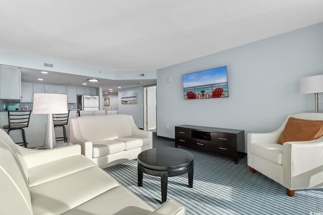 living room featuring carpet, visible vents, and recessed lighting