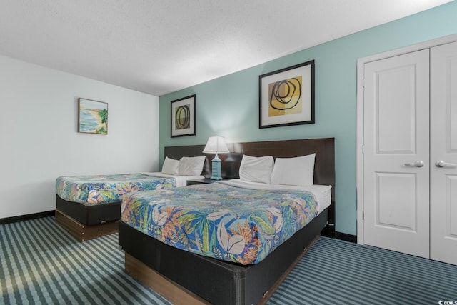 bedroom featuring a closet, carpet flooring, and baseboards