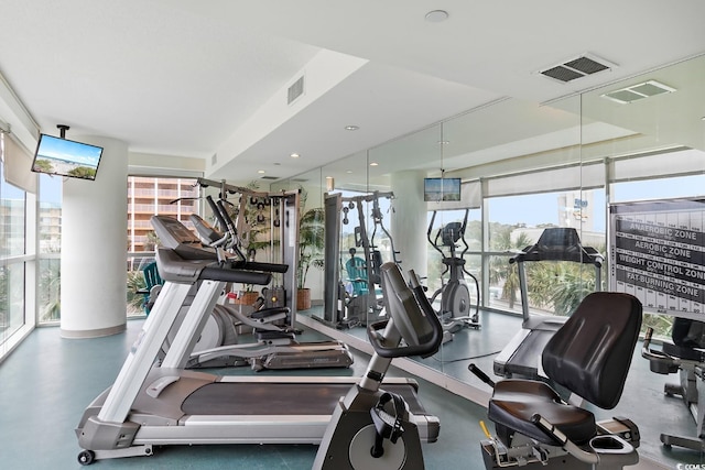 gym with a wall of windows and visible vents