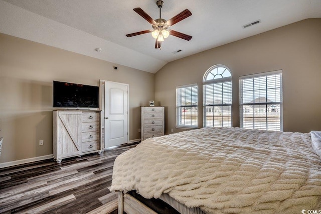 bedroom featuring visible vents, dark wood-type flooring, baseboards, vaulted ceiling, and a ceiling fan